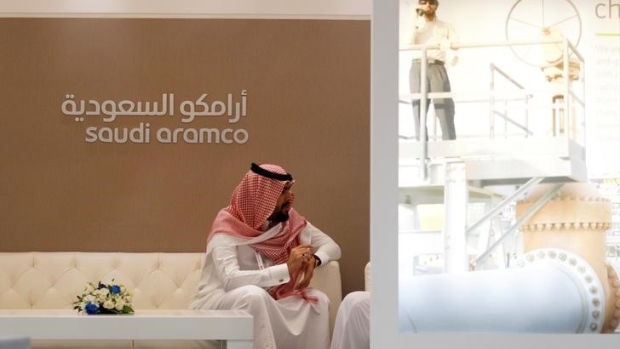a-saudi-aramco-employee-sits-in-the-area-of-its-stand-at-the-middle-east-petrotech-2016.JPG