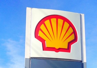 top of a sign displaying the shell logo